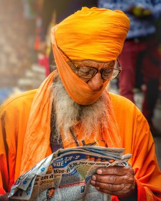 This picture is of a street sikh men wearing a turban and reading a newspaper and representing a community of Sikh religion in India . I asked to sikh men what their turban actually meant for them , they replied :- My sikhi is rest in my turban , If I am not wearing a turban , I am not wearing my pride .