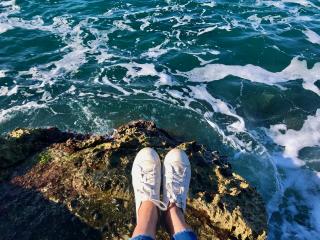 Feet out over the ocean