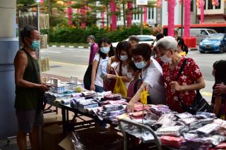 Members of the public picking out face masks for purchase from a road-side stall in the current pandemic situation.