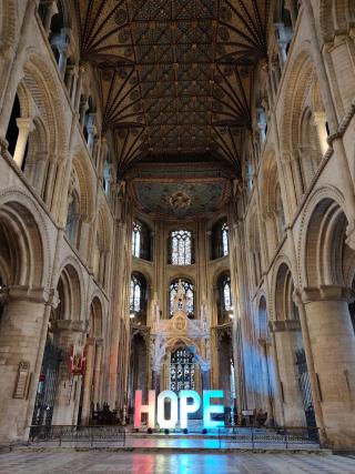 This image was taken in the Peterborough Cathedral in October 2020. We always go to the church with the hope that our prayers are answered, and this enlightened "HOPE" enforced the same in these challenging times. As a student, living alone in a foreign land for the first time, I took this photo to remind myself that there always is hope even in the direst of circumstances.  Everyone is worried about what will happen to the epidemic in the future, which is just like the hazy house in the distance in this ph