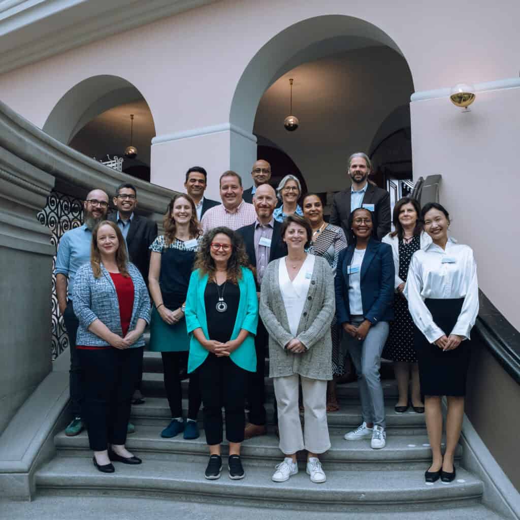 Photo of research collaboration group members standing on steps