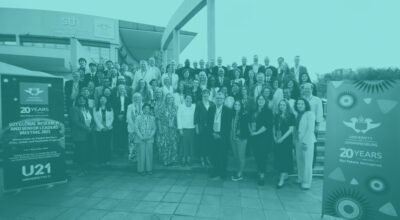 Group photo of delegates from the Global Research & Senior Leaders' Meeting standing in front of University of Johannesburg building
